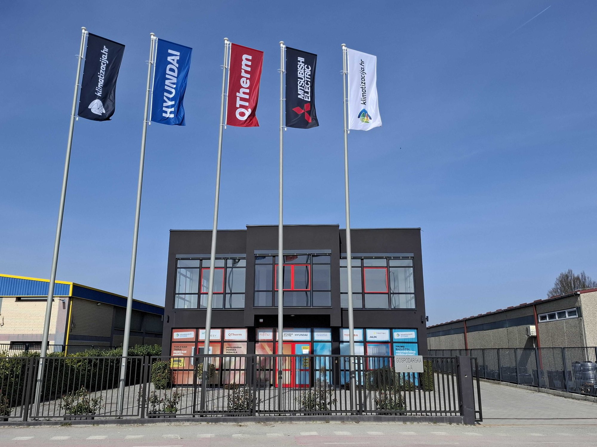 Alfasol branch in Stupnik with brand flags in front of the building